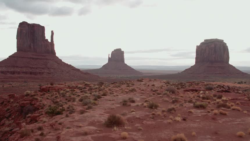 Buttes rise above the desert floor in monument valley in daylight