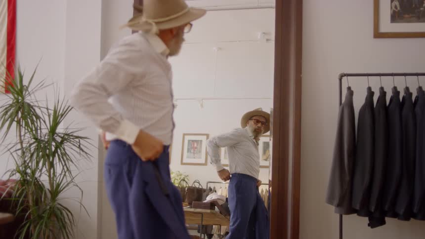 A man tries on clothes in a clothing store