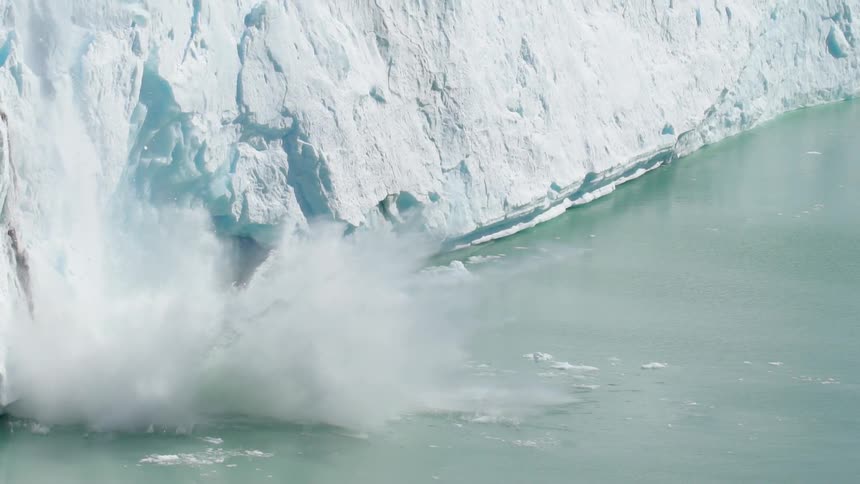 Pieces of ice fall into the water below