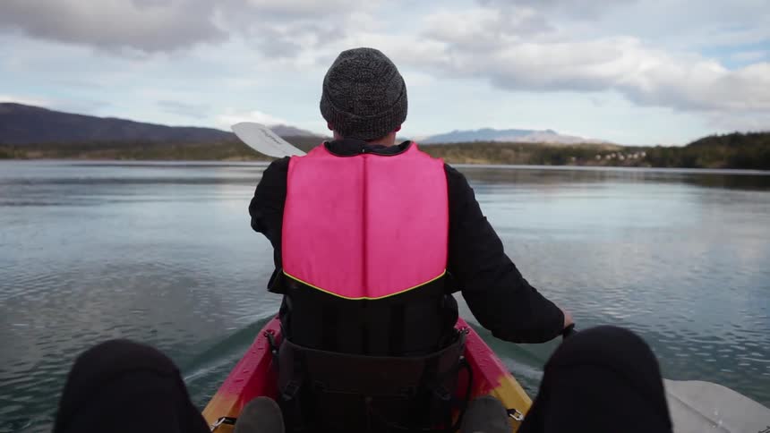 A person is rowing a boat in the lake
