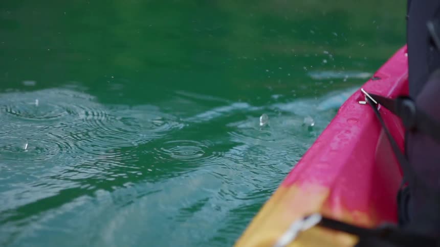 A person kayaks on water