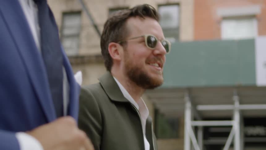 Bearded men walk down the street on a sunny day