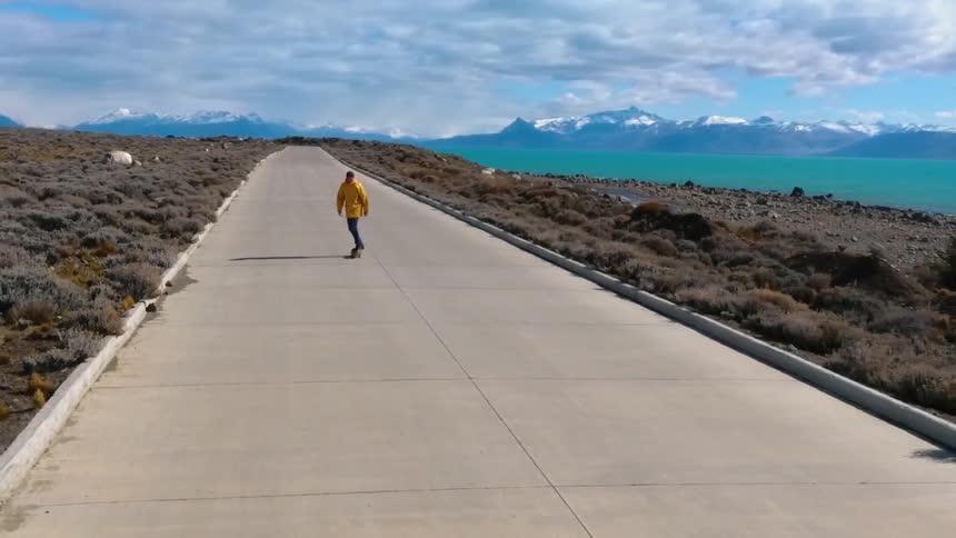 A person is skateboarding down the long road