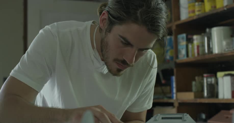 Man uses a sponge to rub down his project