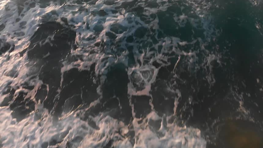 Ocean waves come to shore on a sandy beach