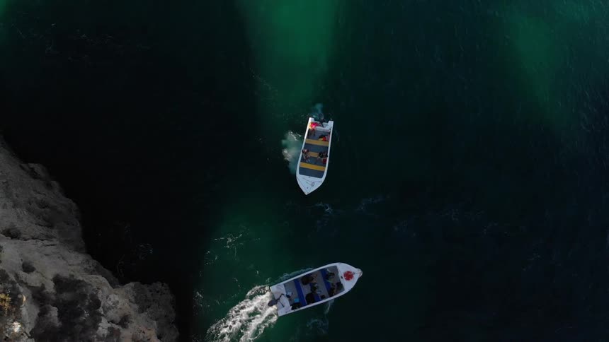 Two boats turn and go in different directions