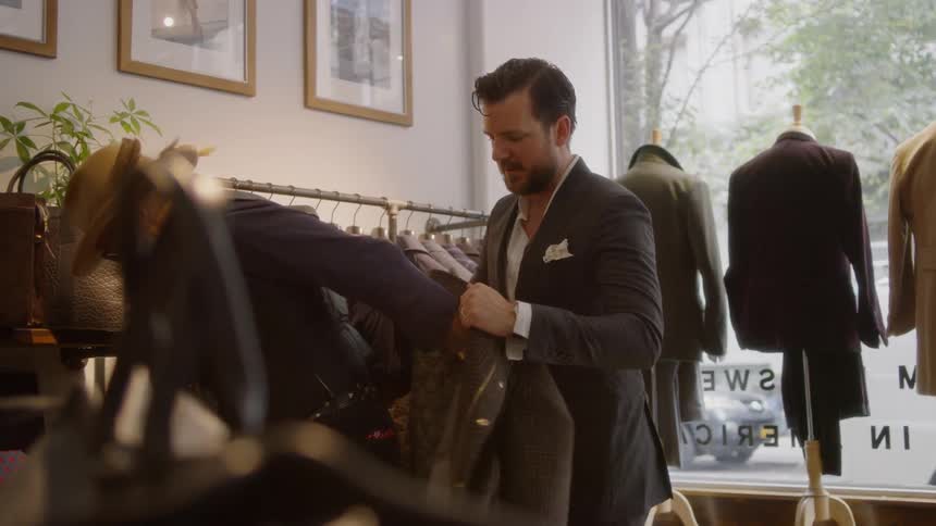 A man tries on a suit in a clothing store