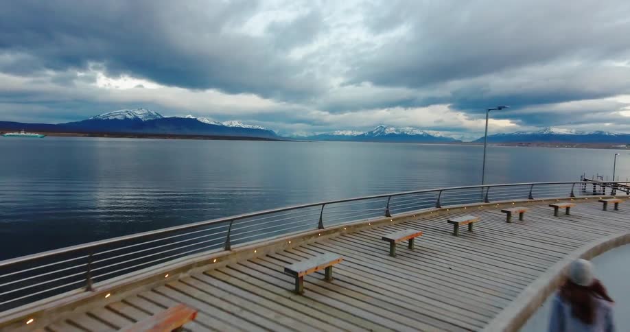A girl is skateboarding by the lake