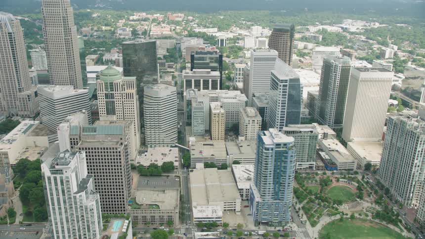 The city has tall buildings and parks below