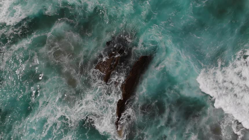 The waves are rough and crashing against the shore