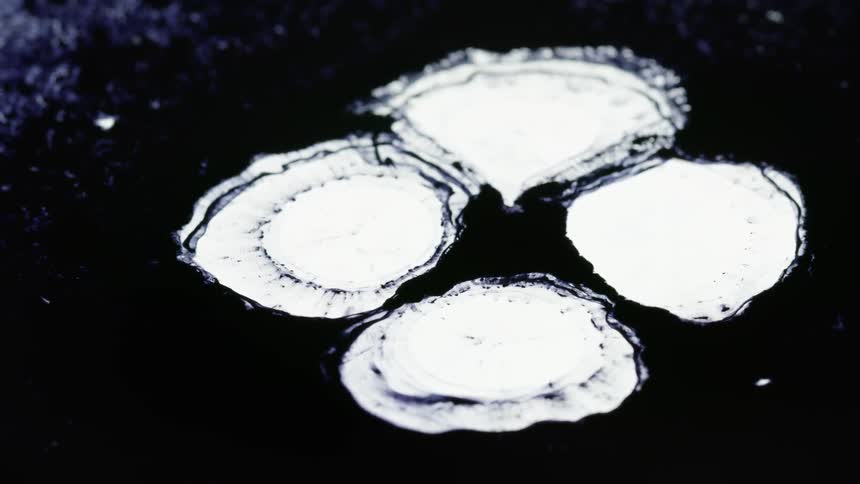 White images and drops are projected on a black surface