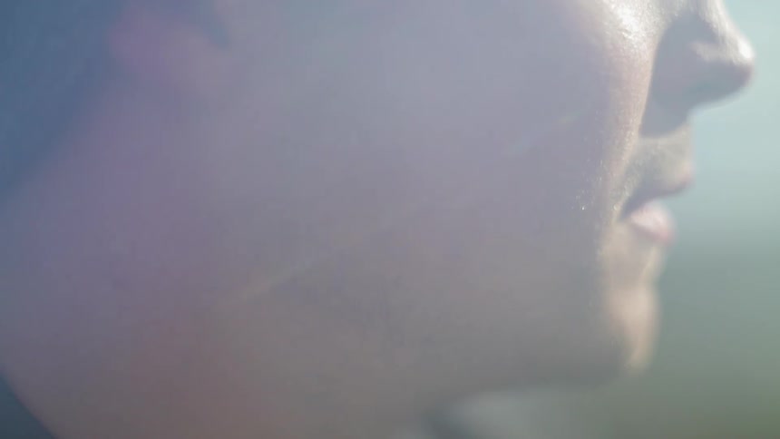 A man is outside smoking a cigarette