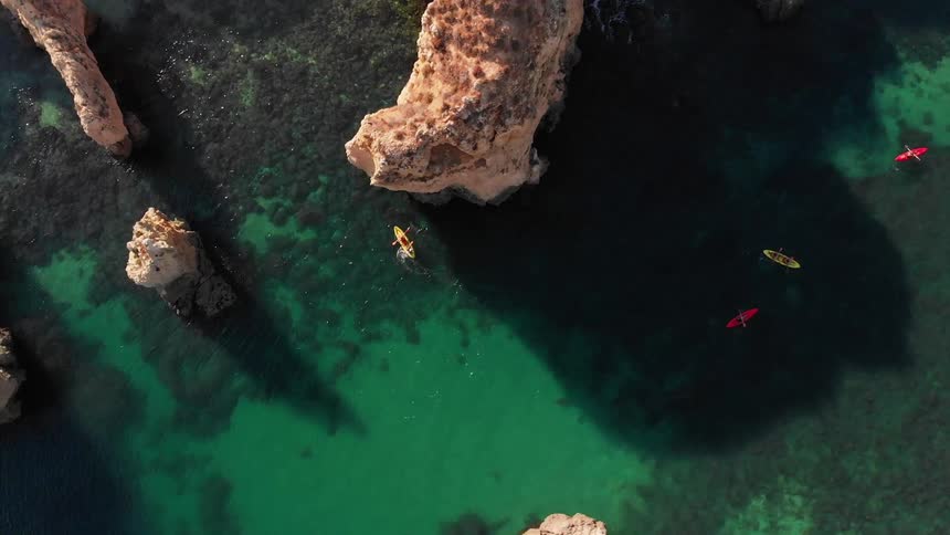 People kayak on the ocean