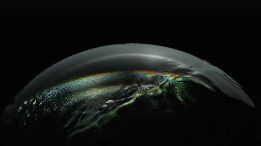 Greens and gold colors and images projected onto an orb
