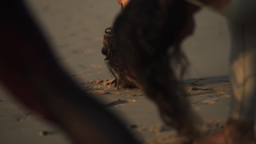 Women do yoga on a beach
