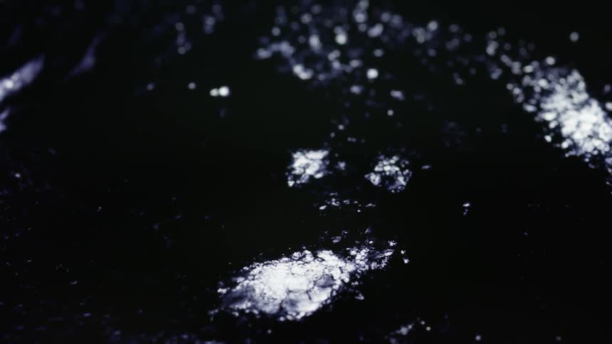 The black surface has bits of white bubbling up