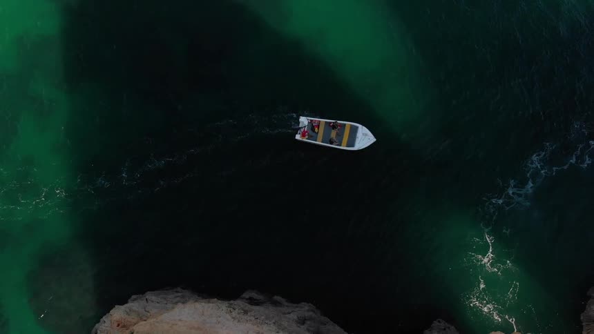 A boat floats on the ocean