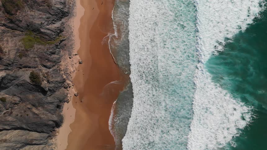 Ocean waves wash ashore a sandy beach