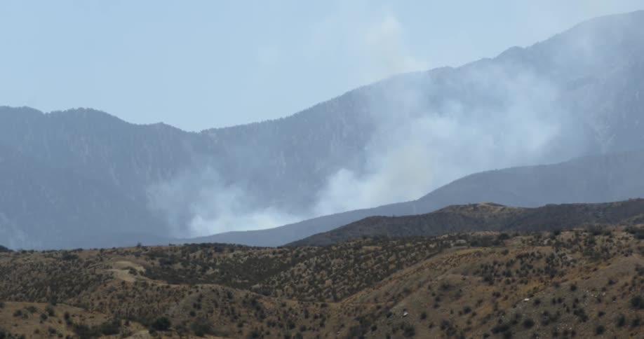 Smoke rises from mountains