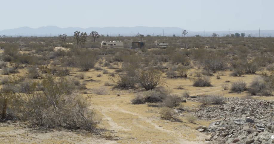 A recreational vehicle is parked on the desert