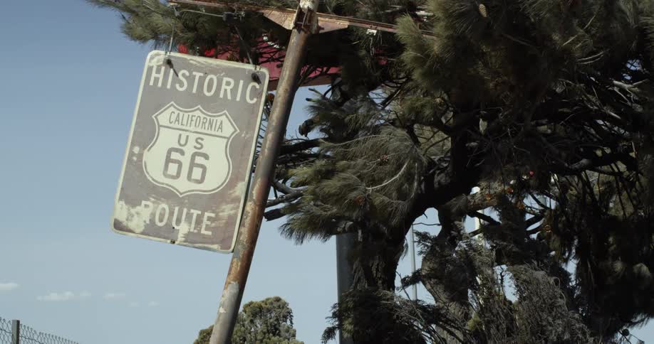A highway sign blows in the wind
