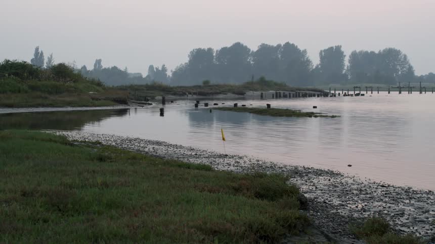 Water flows on a rural lake at sunset