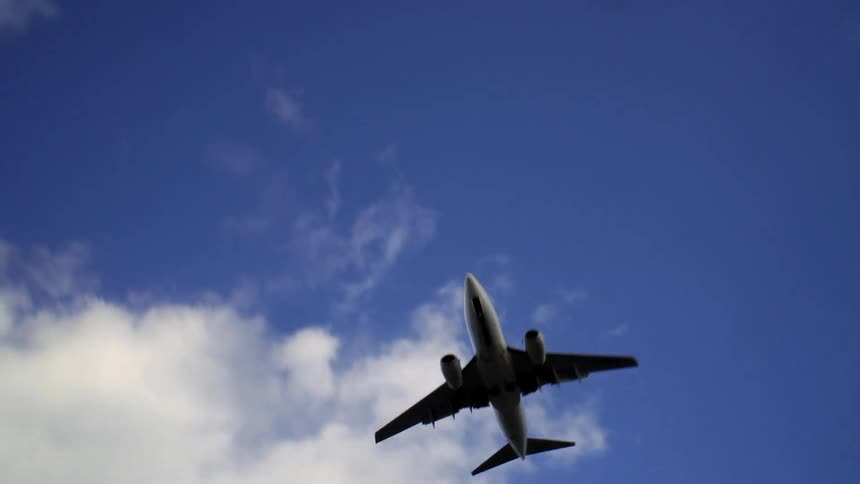 Jet flies under a blue sky