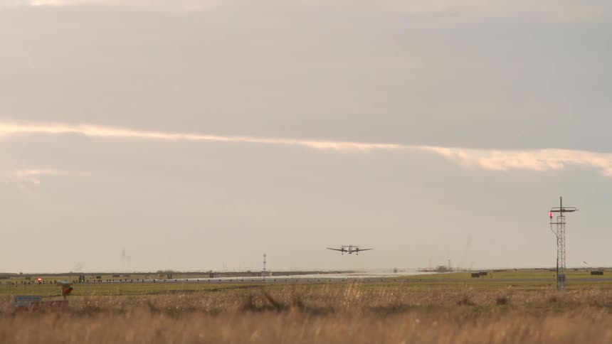 A plane travels down the runway