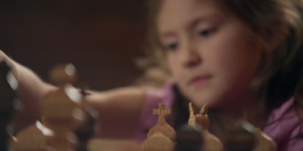 A girl is playing chess