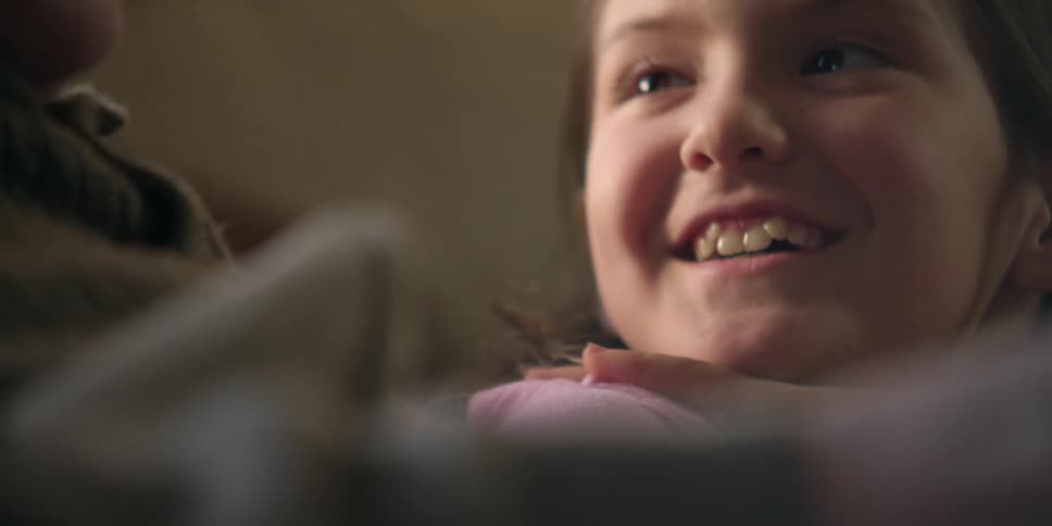 A young girl smiles and laughs