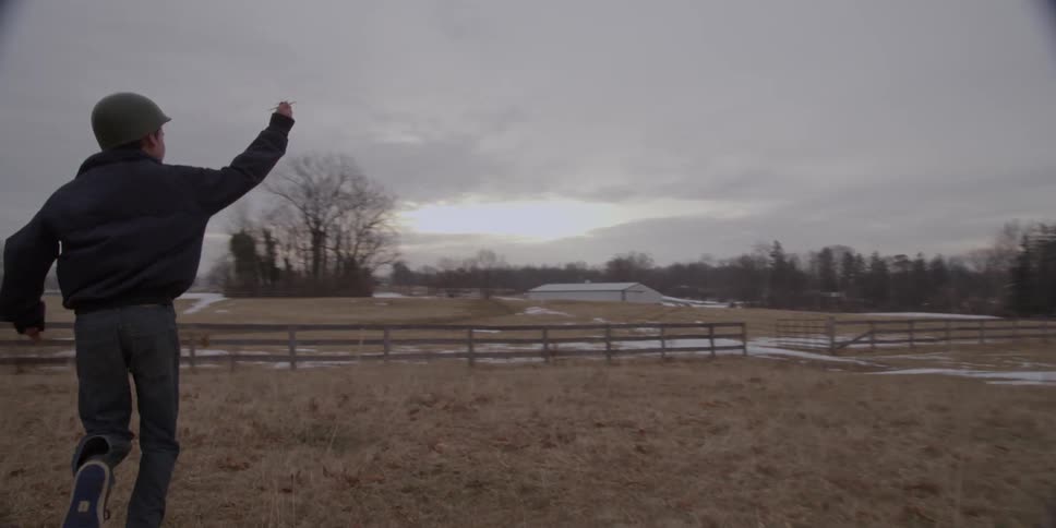 Child running through a pasture on an overcast day