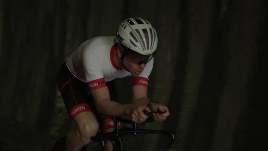 A bicyclist rides through a tunnel
