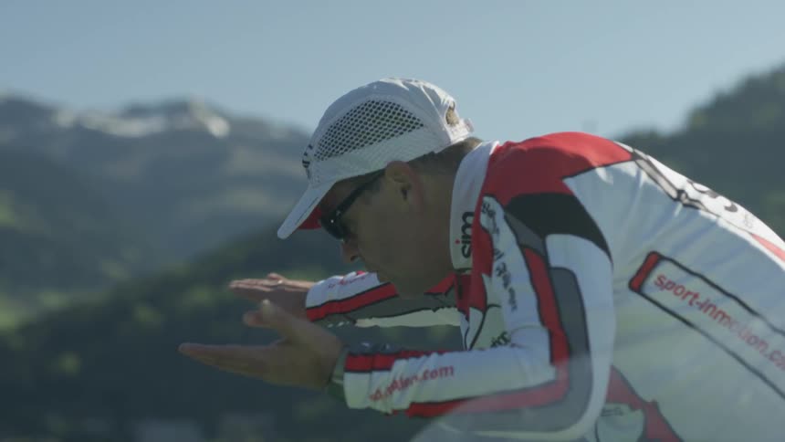 A coach is describing a motion outside on a sunny day