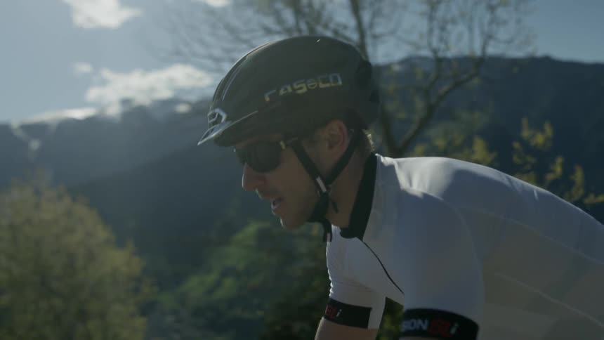 A bicyclist rides on a mountain road