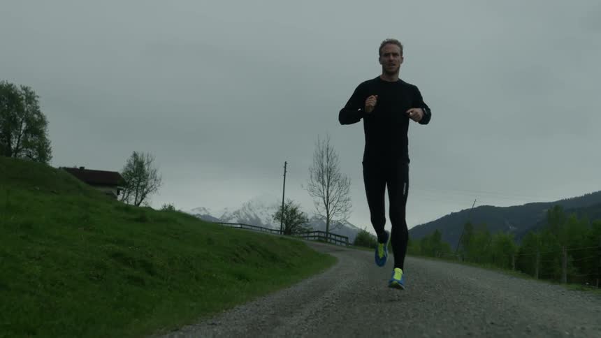 A man jogs on a rural road