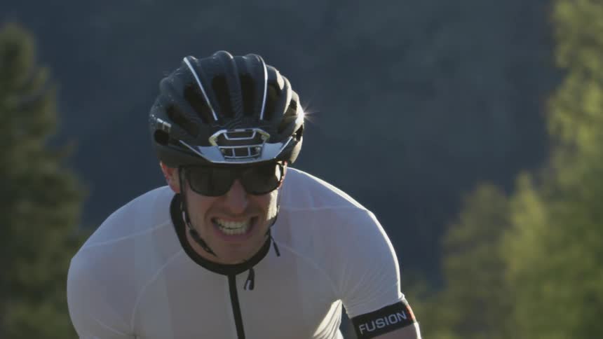 A man is struggling as he rides his bicycle