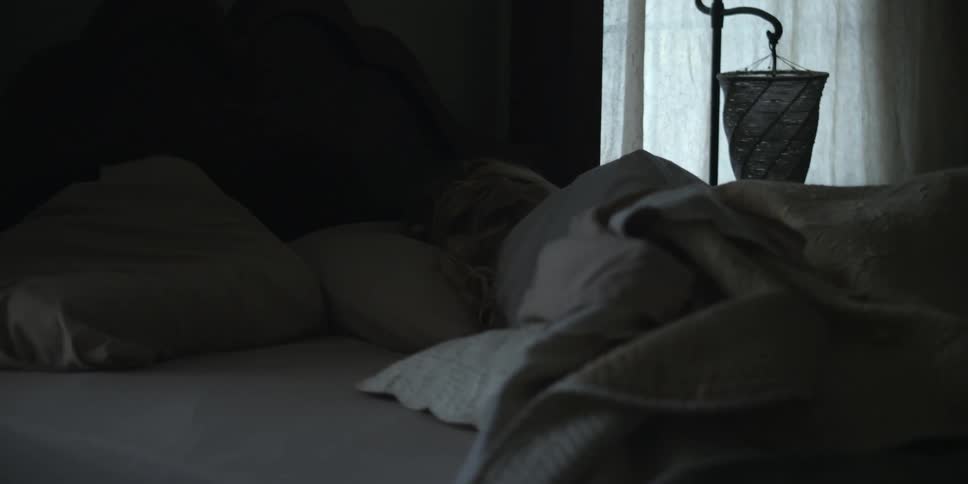 A woman is asleep in bed