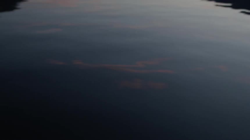 Clouds are reflecting in a river tide at dusk