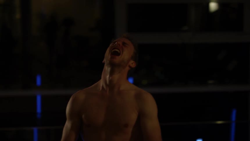 A man sweats and breathes heavily while working out