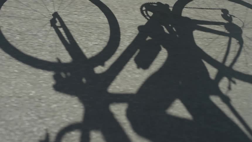 A bicyclist rides on asphalt