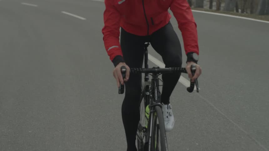 Person rides a bike down a road