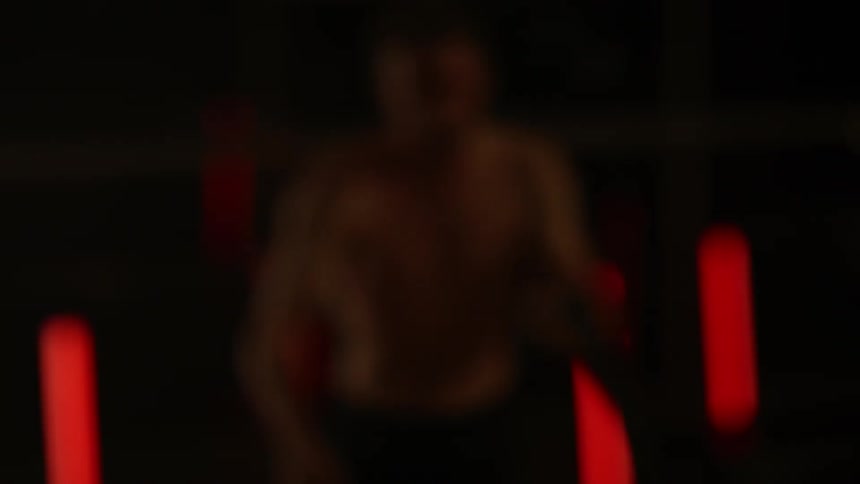 Person slams ropes on the floor in a dark room