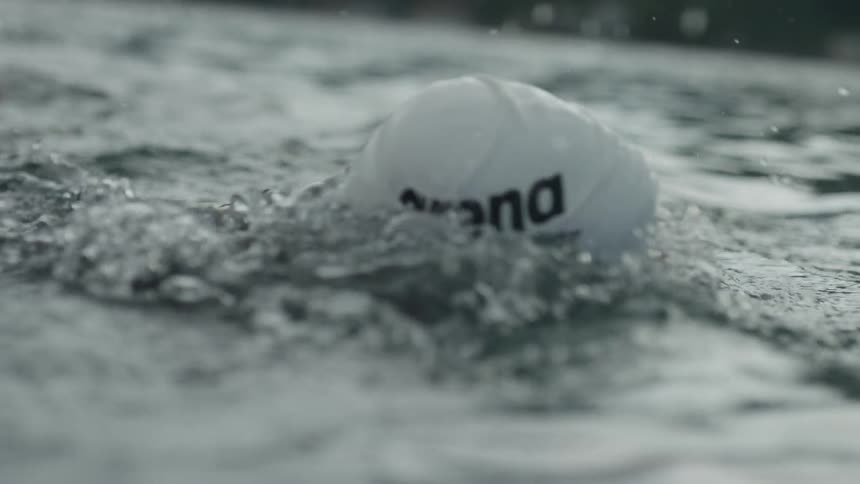 A man swims in a lake
