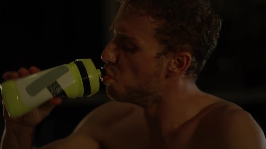 A man drinks from a water bottle