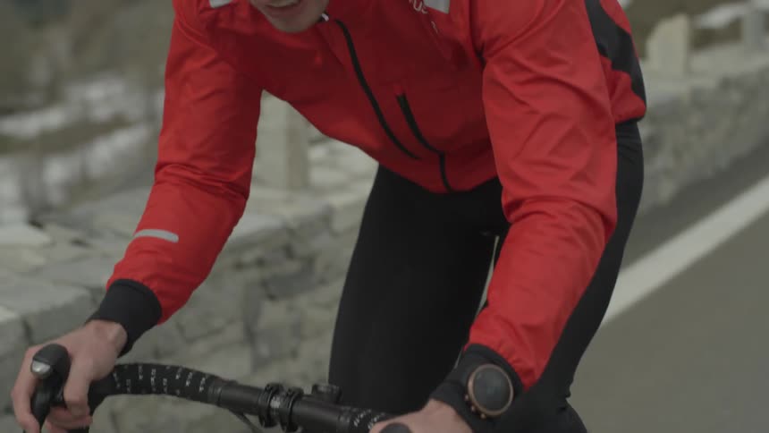 A bicyclist rides on a mountain road