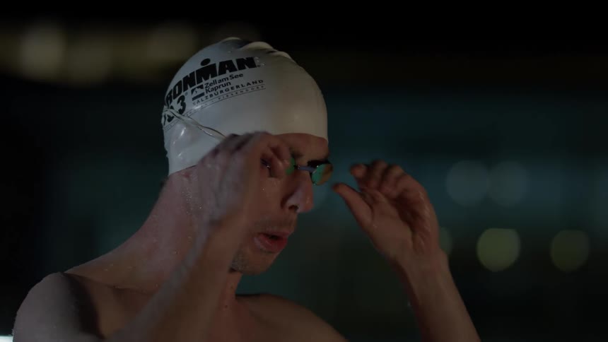 A swimmer prepares to dive into the water