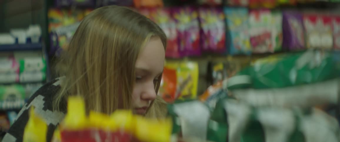 A girl looks at snacks in a convenience store