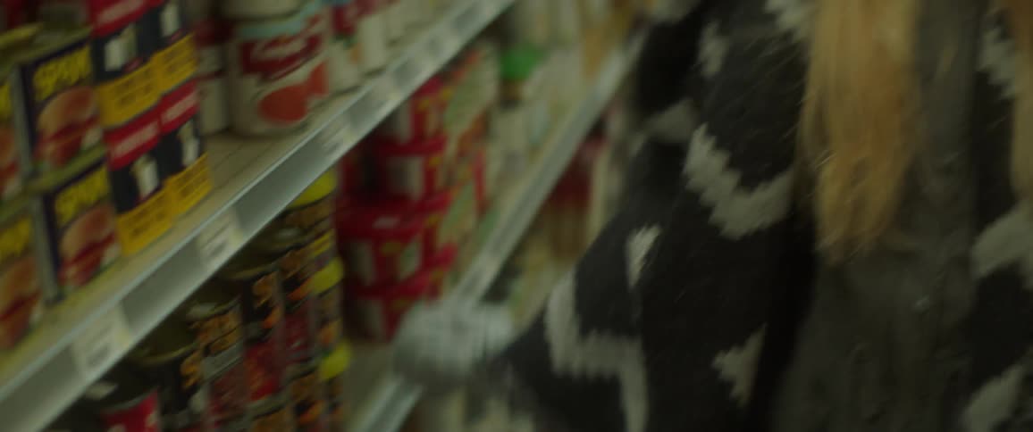 A young woman walks through a store