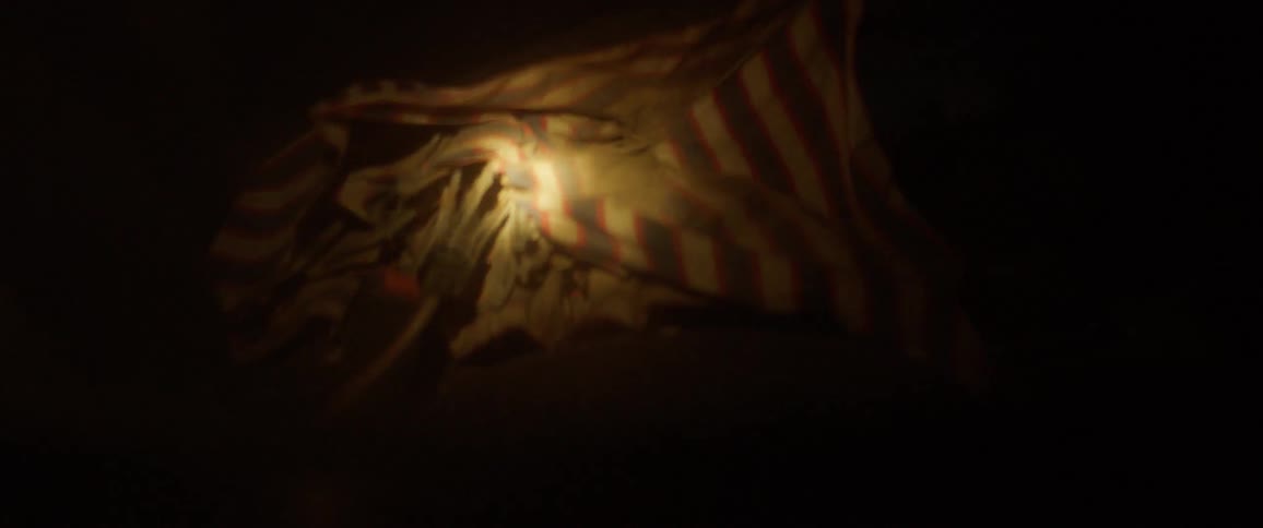 A person shines a flashlight onto a car