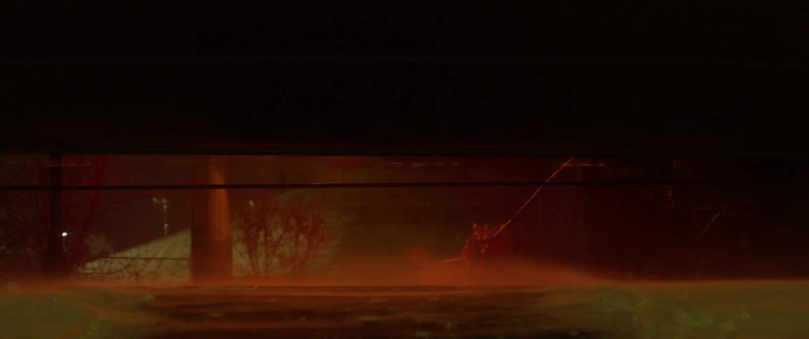 A train travels down the tracks at night